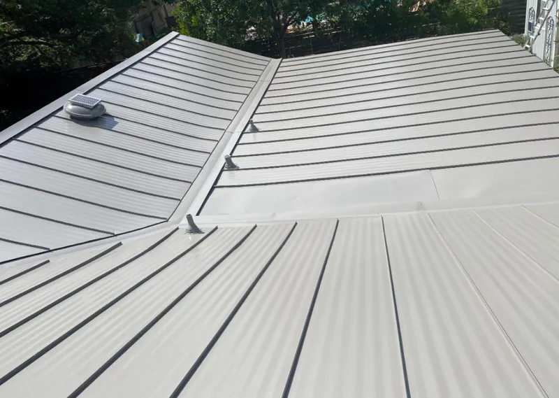 Solar attic fan installed on a metal roof for Roof Ventilation in Oak Ridge