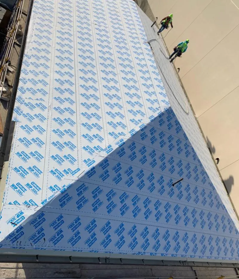 Professional roofers installing underlayment on a metal roof in Oak Ridge